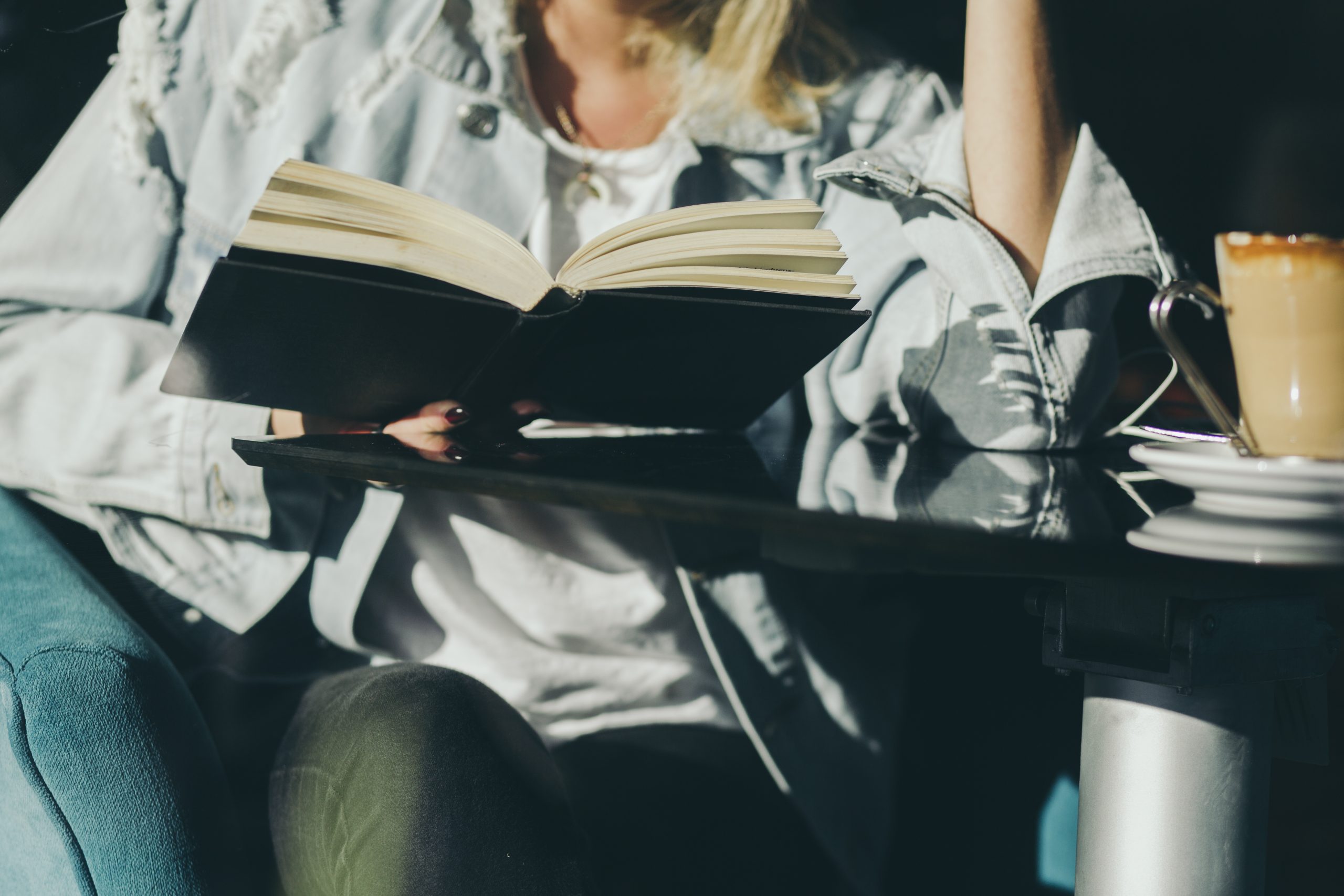 crop-woman-reading-cafe-scaled.jpg