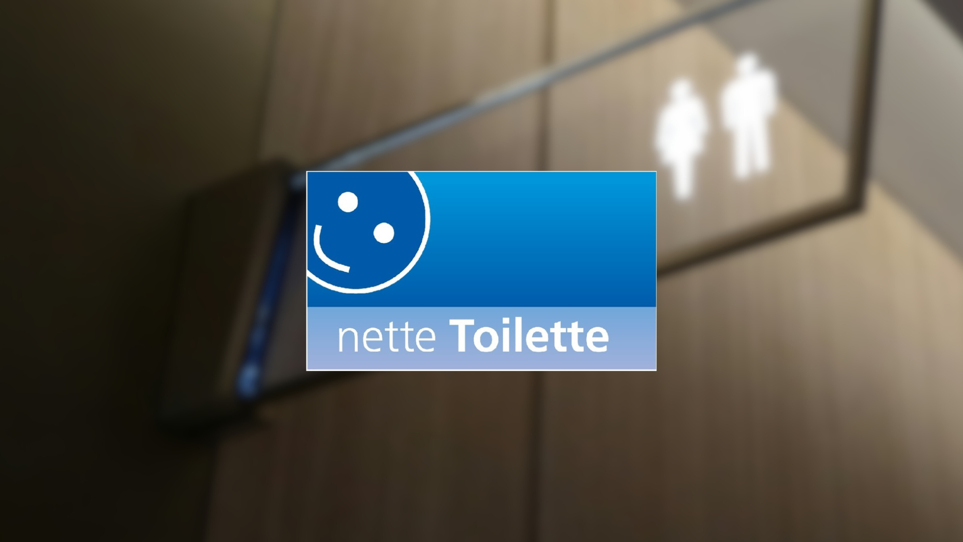 Ein verschwommenes Bild eines Toilettenschildes mit dem Logo für die nette Toilette in Winterberg im Vordergrund. Dieses Bild dient als Symbolbild für öffentliche Toiletten. Ein verschwommenes Bild eines Toilettenschildes mit dem Logo für die nette Toilette in Winterberg im Vordergrund. Dieses Bild dient als Symbolbild für öffentliche Toiletten.